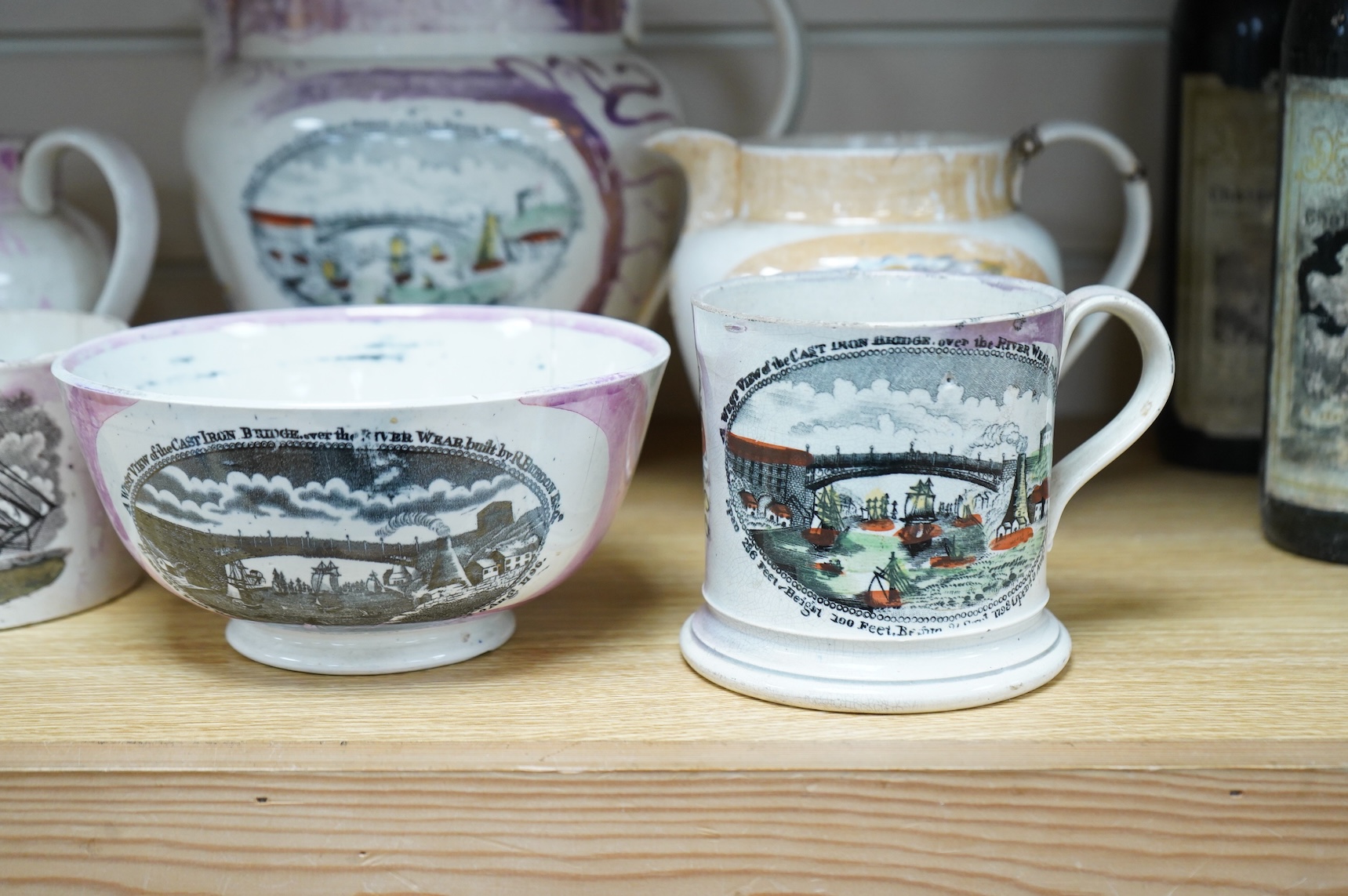 Six early 19th century commemorative jugs and bowls, three with transfer printed scenes of the cast iron bridge over the River Wear commemorating the opening in 1796, together with three others with naval themes, largest